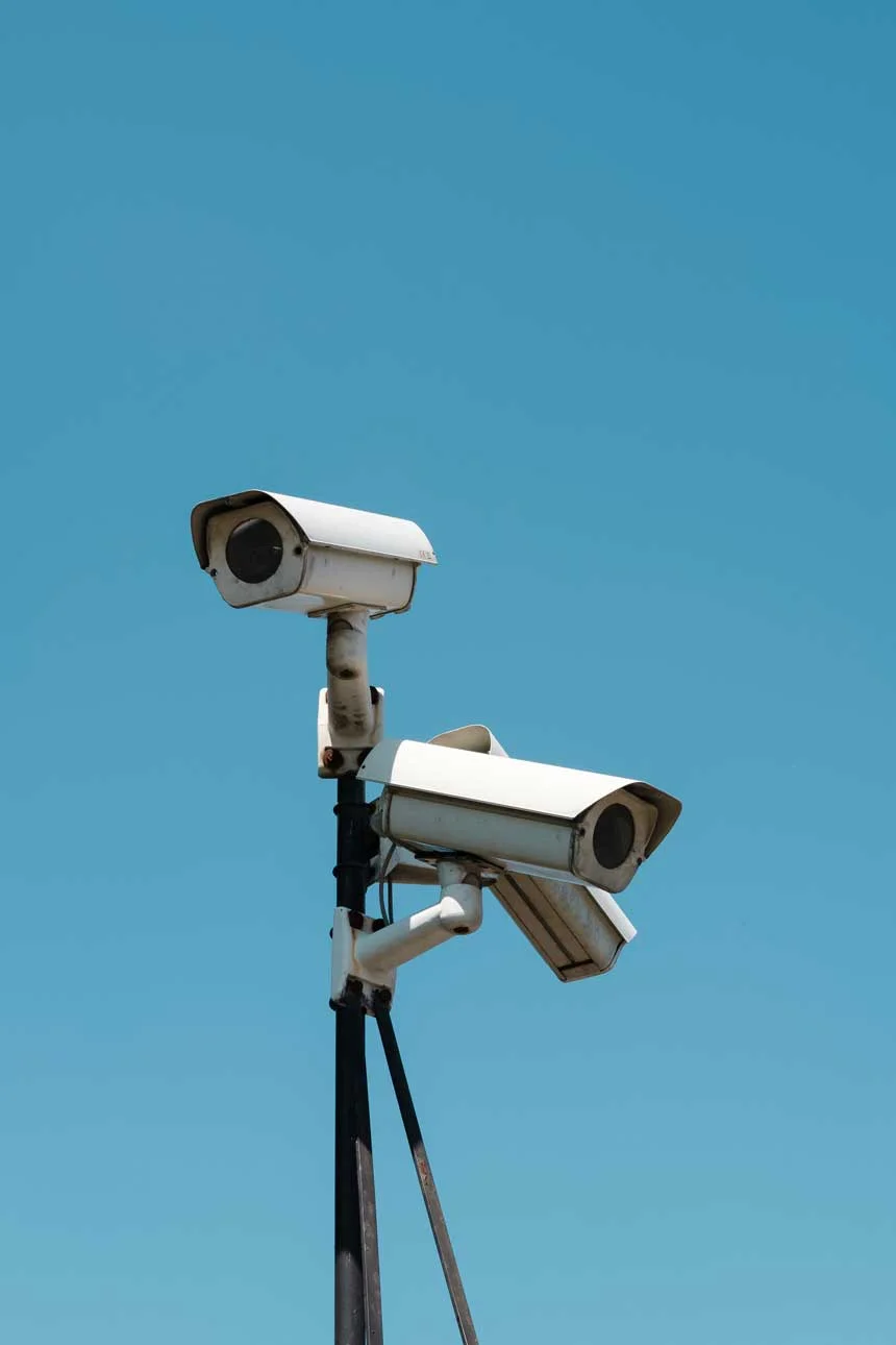 Two outdoor CCTV security cameras mounted on a pole